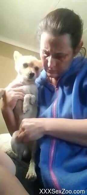 Aroused woman shows off sucking her dog's little cock on cam