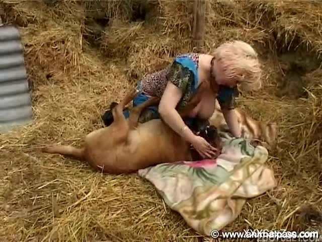 Sensual mature blonde fucks with a big trained doggy at the hayloft
