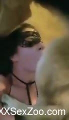 Seductive brunette deepthroating a dog's cock