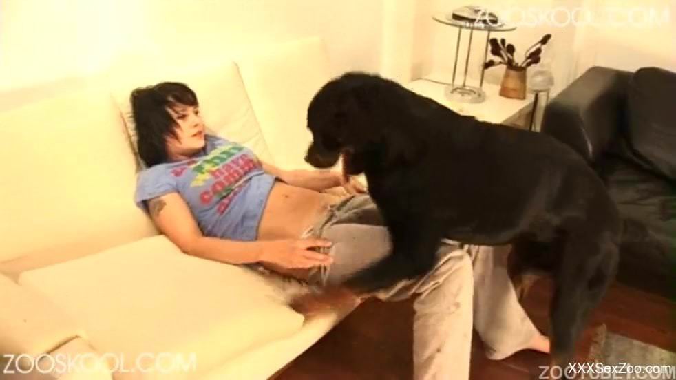 Brunette in tight jeans is fucking her black dog